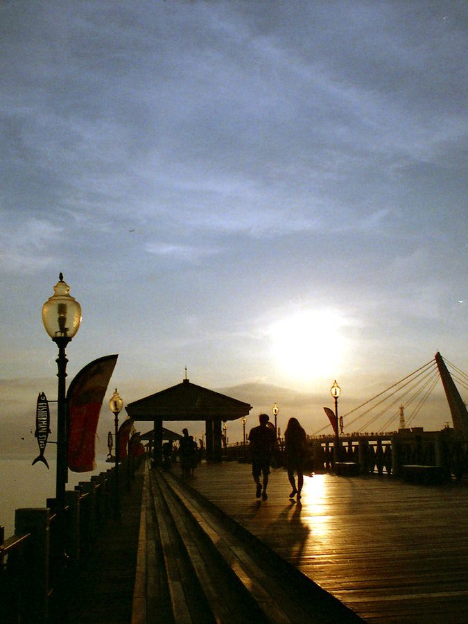 People on the Boardwalk at Sunset